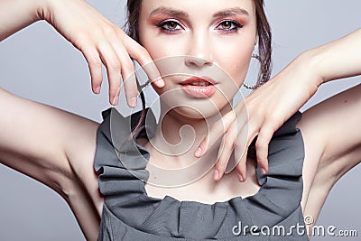 Portrait of young woman in gray dress on grÐµy background Stock Photo