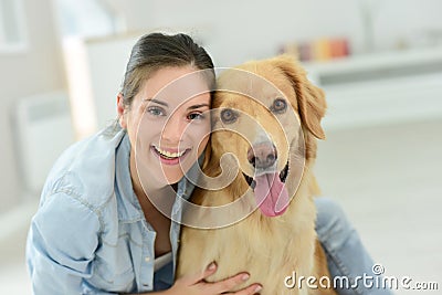 Portrait of young woman petting her dog Stock Photo