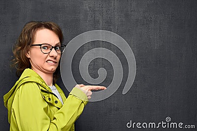 Portrait of young woman pointing at something disgusting Stock Photo
