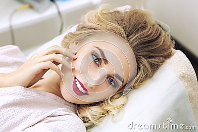 Portrait of a young woman relaxing in spa in bathrobe Stock Photo