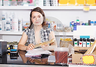 seller working with documents and goods in pet store Stock Photo