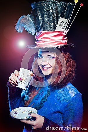 Portrait of young woman in the similitude of the Hatter drinking Stock Photo