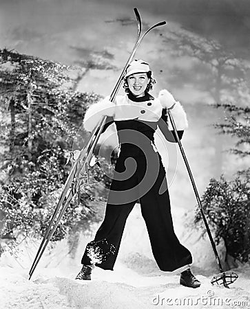 Portrait of a young woman skiing and smiling Stock Photo