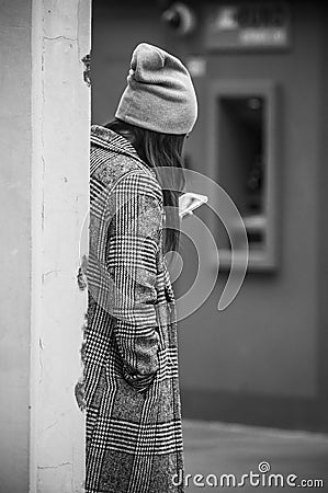 Portrait of young woman standing in the street with smartphone i Editorial Stock Photo