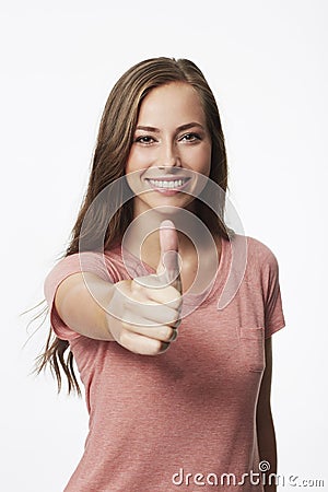 Portrait of young woman with thumbs up Stock Photo