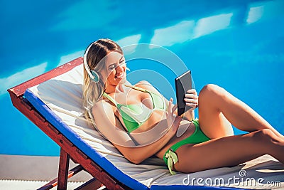 Portrait of young woman in the tropical sun near swimming pool Stock Photo