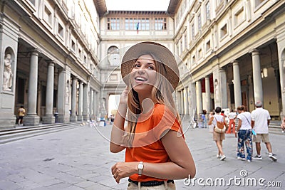 Portrait of young woman walking in courtyard of historic Uffizi Gallery art museum in Florence, Tuscany, Italy Stock Photo