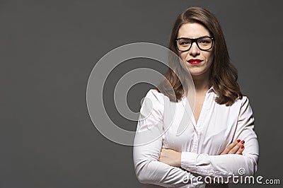Portrait of young woman wearing pink shirt with crossed arms Stock Photo