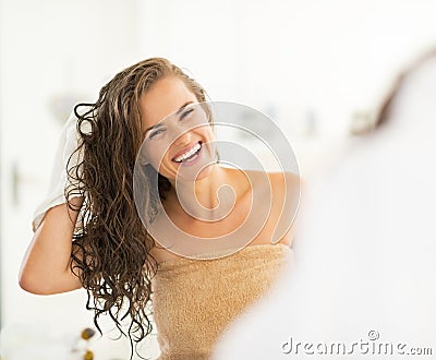 Portrait of young woman wiping hair with towel Stock Photo