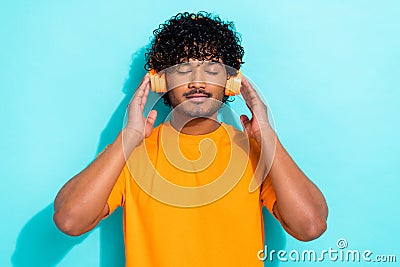 Portrait of youngster relax guy comfort enjoy listen music satisfaction meditation wireless headphones isolated on blue Stock Photo