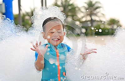 Portraits of happy little Asian baby boy smiling having fun in Foam Party at the pool outdoor Stock Photo