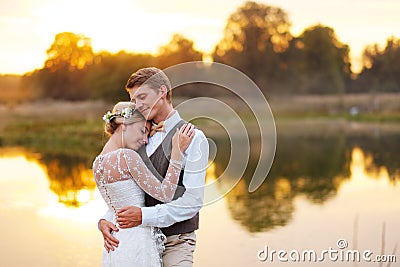 Portraits of a newly married couple. The wedding couple is standing on the background of the order. Stock Photo