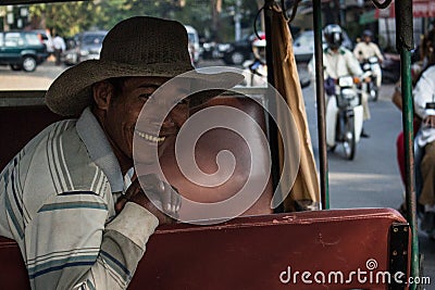 Portratit of a smiling man in his tuktuk in Cambodia Editorial Stock Photo