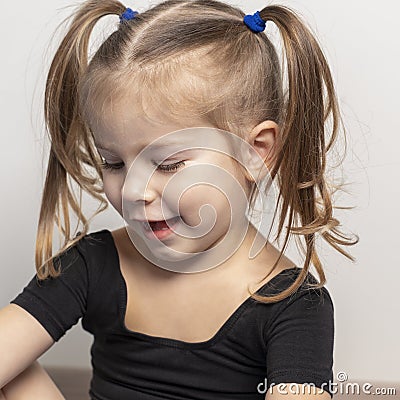 Portret of a beautiful emotional 4 year old girl with two ponytails Stock Photo