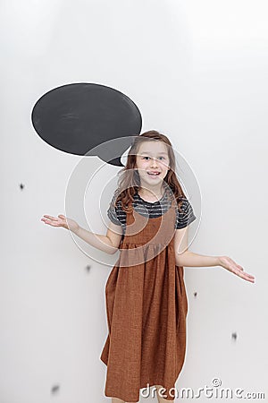 portret emotional 7 year old girl on white background. baby girl shows the emotion of fun. mock up on wall Stock Photo