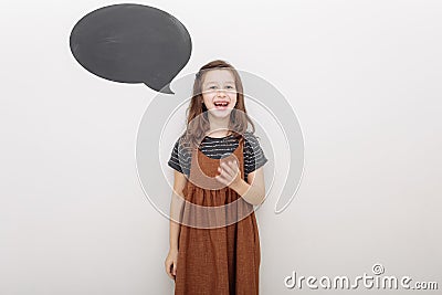 portret emotional 7 year old girl on white background. baby girl shows the emotion of fun. mock up on wall Stock Photo