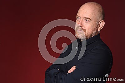 Portriat of a bald man with arms crossed Stock Photo