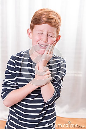 Portriat small boy having tooth ache Stock Photo