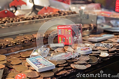 A close up of the coins on a coin push game at an amusement arcade Editorial Stock Photo