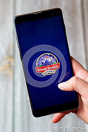 03-22-2021 Portsmouth, Hampshire, UK A mobile phone or cell phone being held in a hand with the Alton Towers app open on screen Editorial Stock Photo