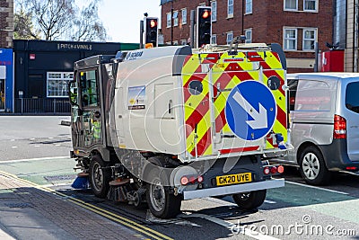 04/01/2020 Portsmouth, Hampshire, UK A road sweeper or road sweeping van driving on the roadside Editorial Stock Photo