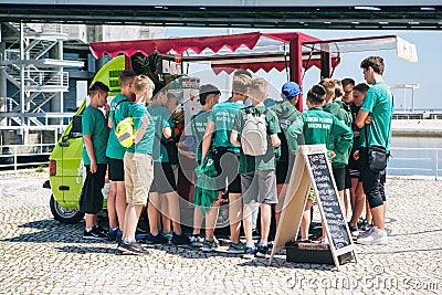 Portugal, Lisbon 29 april 2018: pupils at street buy street food or fresh juice. Editorial Stock Photo