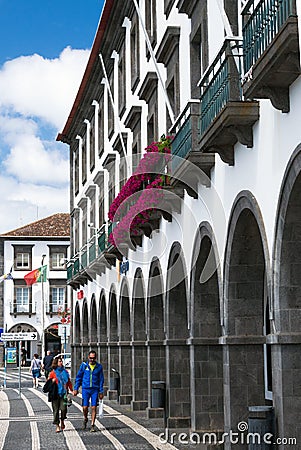 Two lovers hold hands and walk the streets of Ponta Delgada. Editorial Stock Photo