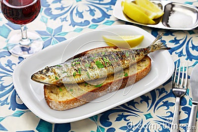 Portuguese grilled sardine on toasted bread Stock Photo