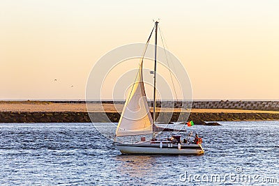 Portuguese Sailboat Passes by at Dusk Editorial Stock Photo