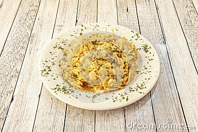Portuguese style dourada cod with lots of parsley and straw potatoes Stock Photo