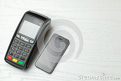 POS terminal, Payment Machine with mobile phone on white background. Contactless payment with NFC technology. Stock Photo