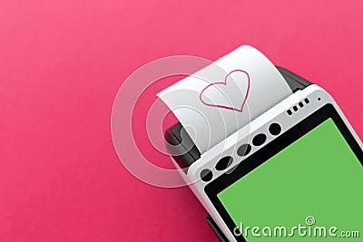 POS terminal with printed reciept with a pink heart picture on a pink background with a space for your copy. Happy Stock Photo