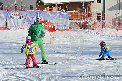 Posa Khutor, Sochi, Russia, January, 26, 2018. The instructor teaching little boys to go skiing on the child`s training slope in t Editorial Stock Photo