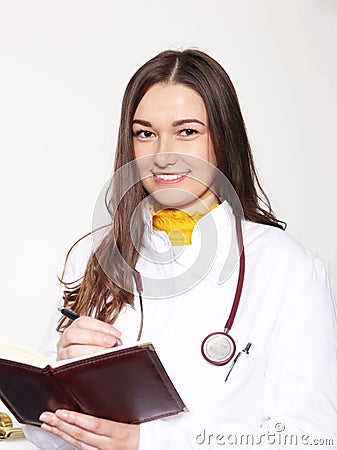 She poses in a doctor`s coat. With a book where she writes down her obligations.Ph1 Stock Photo