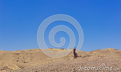 Posing woman portrait Israeli desert landscape colorful travel photography human emotion concept vivid blue sky background empty Editorial Stock Photo