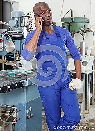 Worker talking on phone Stock Photo