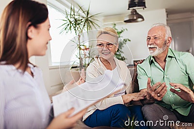 Aged couple consulting with insurance agent Stock Photo