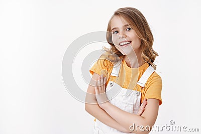 Positive ambitious cute little blond girl, child feeling upbeat and self-assured smiling delighted, look with blue eyes Stock Photo