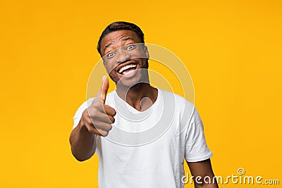 Positive Black Man Gesturing Thumbs Up Standing Over Yellow Background Stock Photo