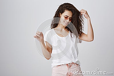 Positive and bright girl enjoys every moment. Portrait of stylish attractive slender woman in trendy sunglasses, posing Stock Photo