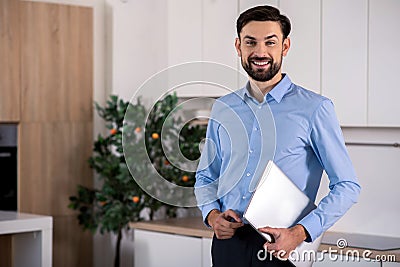 Positive businessman holding his laptop Stock Photo