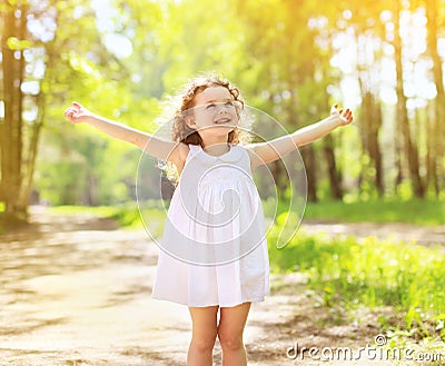 Positive charming curly little girl enjoying summe Stock Photo