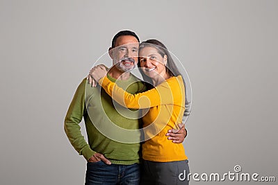 Positive cheerful caucasian retired couple hugs, enjoy date together, romance and positive lifestyle Stock Photo