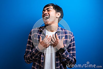 Positive cheerful male closing eyes tight cannot stop laughing at good joke Stock Photo