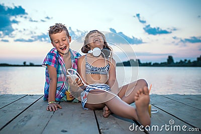 Positive children playing with smartphone Stock Photo