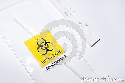 Positive covid self-test and swab in biohazard bag Stock Photo