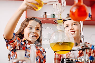 Positive curious girls experimenting Stock Photo