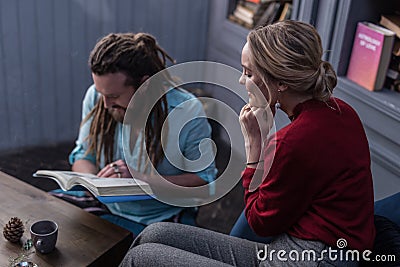 Positive delighted blonde woman touching her chin Stock Photo