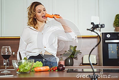 Beautiful plump female person shooting cooking vlog Stock Photo