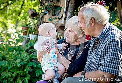 positive emotions for old people grandparents and grandson Stock Photo